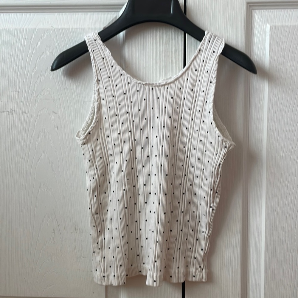 White tank top with black polka dots. Ruffled outline. For young teens